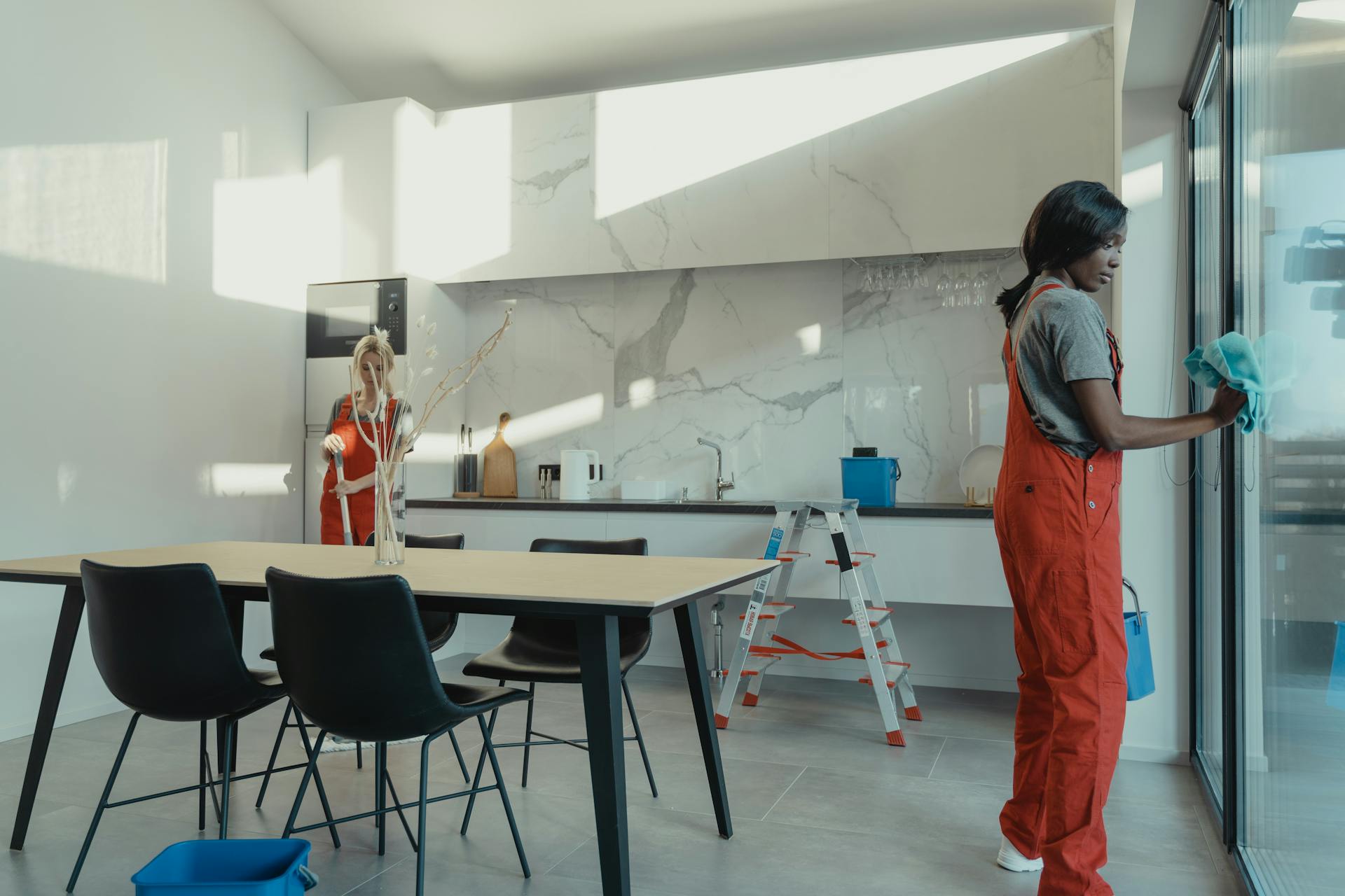 Two cleaners cleaning an office space